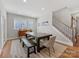 Dining room with lots of natural light from large windows and door, paired with a large dark wood table at 5013 Watercrest Trl, Belmont, NC 28012