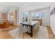 Spacious dining room with a long table, modern chairs, bright windows, and a view of the backyard at 5013 Watercrest Trl, Belmont, NC 28012
