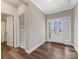 Bright entryway featuring wood flooring, white trim, and a glass-paneled front door with side lights at 5013 Watercrest Trl, Belmont, NC 28012