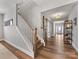 Inviting entryway features a staircase, hardwood floors, stylish barn doors, and soft, neutral paint at 5013 Watercrest Trl, Belmont, NC 28012