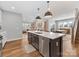 Open concept kitchen island with stainless steel dishwasher overlooking living and dining areas at 5013 Watercrest Trl, Belmont, NC 28012