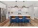 Bright kitchen features a large island with seating and stylish pendant lighting at 5013 Watercrest Trl, Belmont, NC 28012