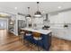 Spacious kitchen featuring a central island with barstools, sleek lighting, and modern appliances at 5013 Watercrest Trl, Belmont, NC 28012