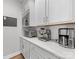 Kitchenette with sleek stainless steel appliances, white countertop and white custom cabinetry at 5013 Watercrest Trl, Belmont, NC 28012
