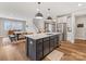 Island kitchen boasts stainless steel appliances, sink and breakfast bar with open floor plan at 5013 Watercrest Trl, Belmont, NC 28012