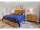 Main bedroom featuring natural wood furnishings, blue linens, and neutral decor at 5013 Watercrest Trl, Belmont, NC 28012