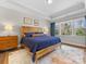 This main bedroom features a wood bed frame, a tray ceiling, lots of natural light, and neutral walls at 5013 Watercrest Trl, Belmont, NC 28012
