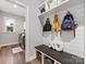 Mudroom featuring a dark wood bench, white shelves, and dark wood-look floors at 5013 Watercrest Trl, Belmont, NC 28012