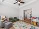 Open playroom includes gray furniture, a colorful rug, with natural lighting, perfect for to play and learn at 5013 Watercrest Trl, Belmont, NC 28012