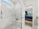 Walk in shower featuring marble tiles, a built-in bench, and a view through a doorway to the main bedroom at 5013 Watercrest Trl, Belmont, NC 28012
