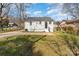 Home exterior featuring a grassy backyard, a driveway, and mature trees at 502 Crawford St, Shelby, NC 28150