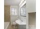 Bathroom featuring a vanity with sink, toilet, window, and a tile backsplash at 502 Crawford St, Shelby, NC 28150