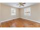 Well-lit bedroom with hardwood flooring, two windows, neutral paint, and white trim details at 502 Crawford St, Shelby, NC 28150
