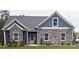 Charming single-story home with stone and siding accents, complemented by a well-manicured lawn at 506 Muirfield Way, Salisbury, NC 28144