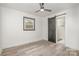 Bedroom with light-colored wood-look flooring, fan, window, and barn door to bathroom at 5674 Alan D Good Ln, Conover, NC 28613