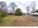 Spacious backyard with lush green grass and mature trees offering ample privacy at 609 Eddleman Rd, Kannapolis, NC 28083