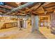 Unfinished basement displaying exposed ceiling, pipes, workbench and furnace at 609 Eddleman Rd, Kannapolis, NC 28083