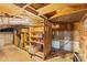Unfinished basement featuring wooden shelving, storage bins, and cinder block walls at 609 Eddleman Rd, Kannapolis, NC 28083