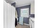 A bathroom with a shower, drawers and a washer and dryer at 609 Eddleman Rd, Kannapolis, NC 28083
