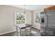 Bright dining room with stainless steel refrigerator, wood floors, and natural light at 609 Eddleman Rd, Kannapolis, NC 28083