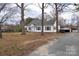 A quaint home with mature trees, a private driveway, and a spacious yard at 609 Eddleman Rd, Kannapolis, NC 28083