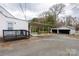 Exterior view showcasing a covered patio, detached garage, and spacious driveway at 609 Eddleman Rd, Kannapolis, NC 28083