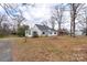 View of a home's exterior with trees on a large lot at 609 Eddleman Rd, Kannapolis, NC 28083