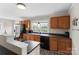 Spacious kitchen featuring wood cabinets, black countertops, and modern appliances at 609 Eddleman Rd, Kannapolis, NC 28083