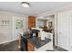 Kitchen with dark countertops, stove top island, and wooden cabinets at 609 Eddleman Rd, Kannapolis, NC 28083