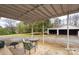 Covered patio featuring seating area and views of the backyard and detached garage at 609 Eddleman Rd, Kannapolis, NC 28083