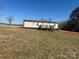 Backyard view of the home showing the deck and siding on the home at 8183 Hallman Mill Rd, Vale, NC 28168