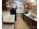 Functional kitchen featuring black appliances, light countertops, and wood cabinets at 8183 Hallman Mill Rd, Vale, NC 28168