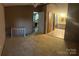 Spacious living room with view to bathroom; features neutral walls and carpet at 8183 Hallman Mill Rd, Vale, NC 28168