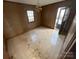 A living room with paneled walls, a chandelier, and a door leading to the outside at 8313 Lamplighter Pl, Charlotte, NC 28217