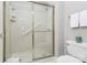 Bathroom with updated shower featuring sleek glass doors and a convenient grab bar at 8462 Highland Glen Dr, Charlotte, NC 28269