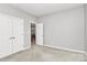 Bright bedroom featuring neutral walls and trim, and double door closet at 8462 Highland Glen Dr, Charlotte, NC 28269