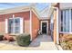 Inviting entryway with a charming front porch and stylish black door featuring a welcoming wreath at 8462 Highland Glen Dr, Charlotte, NC 28269