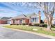 Charming brick home featuring a well-manicured lawn and tidy landscaping under a partly cloudy sky at 8462 Highland Glen Dr, Charlotte, NC 28269
