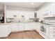 Well-lit kitchen featuring white cabinetry, granite countertops, and modern appliances at 8462 Highland Glen Dr, Charlotte, NC 28269