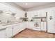 Bright kitchen featuring white appliances, granite countertops, and wood flooring at 8462 Highland Glen Dr, Charlotte, NC 28269