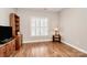 Living room featuring hardwood floors, built in shelves, and large window at 8462 Highland Glen Dr, Charlotte, NC 28269