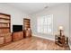 Living room featuring hardwood floors, built in shelves, and large window at 8462 Highland Glen Dr, Charlotte, NC 28269