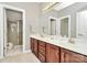 Bright main bathroom featuring double sinks with granite countertops and a tiled shower at 8462 Highland Glen Dr, Charlotte, NC 28269