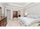Main bedroom featuring a trey ceiling, wood dressers, and ensuite bathroom at 8462 Highland Glen Dr, Charlotte, NC 28269