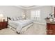 Comfortable main bedroom with neutral carpet, a queen bed and bright windows at 8462 Highland Glen Dr, Charlotte, NC 28269