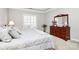 Comfortable main bedroom featuring tray ceiling and window with white shutters at 8462 Highland Glen Dr, Charlotte, NC 28269