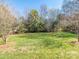 Expansive backyard with mature trees and grass, providing a serene outdoor space at 9307 Harlow Creek Rd, Huntersville, NC 28078
