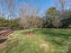 Spacious backyard with mature trees and grass, perfect for outdoor activities and relaxation at 9307 Harlow Creek Rd, Huntersville, NC 28078