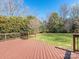 A wooden deck with railing in the back yard provides a great outdoor entertaining space at 9307 Harlow Creek Rd, Huntersville, NC 28078