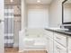 Bright bathroom featuring a shower and tub combination, and a single sink vanity with a dark countertop at 9307 Harlow Creek Rd, Huntersville, NC 28078